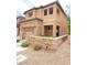 Two-story home with a two-car garage, stone accents, and low-maintenance front yard at 10349 Mystic Pine Rd, Las Vegas, NV 89135