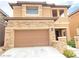 Inviting two-story home with a stone-accented facade and a convenient two-car garage at 10349 Mystic Pine Rd, Las Vegas, NV 89135