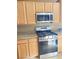 Close-up showcasing the stainless steel oven, granite countertops, and wood cabinets in the kitchen at 10349 Mystic Pine Rd, Las Vegas, NV 89135