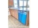Kitchen island view featuring a white sink, gray granite countertop, and stainless steel dishwasher at 10349 Mystic Pine Rd, Las Vegas, NV 89135