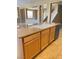 Granite countertops and wood cabinets in this kitchen island create a warm and inviting atmosphere at 10349 Mystic Pine Rd, Las Vegas, NV 89135