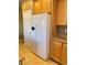 The kitchen offers stainless steel appliances with a large refrigerator and wood cabinets and granite countertops at 10349 Mystic Pine Rd, Las Vegas, NV 89135