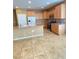 A kitchen features modern appliances, wood cabinets, a granite countertop, and a breakfast bar area at 10349 Mystic Pine Rd, Las Vegas, NV 89135