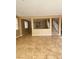 Open-concept living space with tile floors and great natural light with easy access to staircase at 10349 Mystic Pine Rd, Las Vegas, NV 89135
