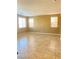 The living room features tile flooring, three windows, and tan-painted walls, enhancing the open feel at 10349 Mystic Pine Rd, Las Vegas, NV 89135