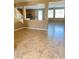 Spacious living area featuring an open layout, tile flooring, and a view of the kitchen at 10349 Mystic Pine Rd, Las Vegas, NV 89135