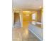 View of the living space with a staircase, tile flooring, granite countertop, and elegant chandelier lighting at 10349 Mystic Pine Rd, Las Vegas, NV 89135