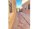 View of the side yard walkway with stone pavers and gravel landscaping at 10349 Mystic Pine Rd, Las Vegas, NV 89135
