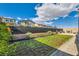 Lush backyard featuring a well-manicured lawn, landscaping, and lounge chairs at 10456 Skye Arroyo Ave, Las Vegas, NV 89166