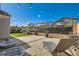 Inviting backyard featuring a well-manicured lawn, landscaping, and lounge chairs at 10456 Skye Arroyo Ave, Las Vegas, NV 89166