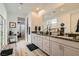 Bathroom featuring dual sinks with granite countertops and gray cabinets with modern fixtures and hardware at 10456 Skye Arroyo Ave, Las Vegas, NV 89166