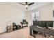Simple bedroom with modern desk setup, shelving, and comfortable lighting fixtures at 10456 Skye Arroyo Ave, Las Vegas, NV 89166