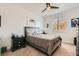 Bedroom with neutral-toned carpet and decor features stylish bedframe, and natural lighting at 10456 Skye Arroyo Ave, Las Vegas, NV 89166