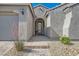 Close up of the front entrance leading to the house through a brick paved path with desert landscaping at 10456 Skye Arroyo Ave, Las Vegas, NV 89166