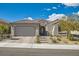 Charming single story home with a two car garage and appealing low maintenance desert landscaping in front at 10456 Skye Arroyo Ave, Las Vegas, NV 89166