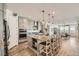 Modern, open-concept kitchen with island, stainless steel appliances, and breakfast bar seating at 10456 Skye Arroyo Ave, Las Vegas, NV 89166