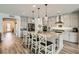 Bright kitchen with gray cabinets, stainless steel appliances, granite countertops, and island with seating at 10456 Skye Arroyo Ave, Las Vegas, NV 89166