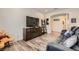 Stylish living room featuring modern furniture, hardwood floors, and a large TV at 10456 Skye Arroyo Ave, Las Vegas, NV 89166