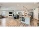 Open-concept living room and kitchen features a fireplace, flat screen TV, and modern décor at 10456 Skye Arroyo Ave, Las Vegas, NV 89166