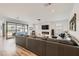 Bright living room featuring modern fireplace, wooden floors, and recessed lighting at 10456 Skye Arroyo Ave, Las Vegas, NV 89166