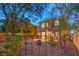 Landscaped backyard with a decorative garden, mature trees, and privacy fence at 11178 Corsica Mist Ave, Las Vegas, NV 89135