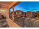 Balcony at dusk, showcasing outdoor seating and neighboring homes at 11178 Corsica Mist Ave, Las Vegas, NV 89135