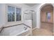 Bathroom with bathtub, separate shower and shuttered window at 11178 Corsica Mist Ave, Las Vegas, NV 89135