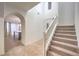 Stairway and entryway with view into an open-concept kitchen and dining space, featuring white trim at 11178 Corsica Mist Ave, Las Vegas, NV 89135