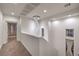 Upstairs hallway featuring a stylish spiral chandelier and neutral decor at 11178 Corsica Mist Ave, Las Vegas, NV 89135