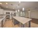 Modern kitchen with stainless steel appliances, a large island, and pendant lighting at 11178 Corsica Mist Ave, Las Vegas, NV 89135