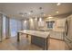 Bright kitchen featuring a center island, stainless appliances, recessed lighting, and a double sink at 11178 Corsica Mist Ave, Las Vegas, NV 89135