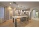 Spacious kitchen featuring stainless steel appliances, center island with white counters, and modern pendant lighting at 11178 Corsica Mist Ave, Las Vegas, NV 89135