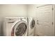 Laundry room equipped with a white washer and dryer set, and a white door at 11178 Corsica Mist Ave, Las Vegas, NV 89135