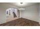 Bright living room with a staircase, wood and tile flooring, and white walls at 11178 Corsica Mist Ave, Las Vegas, NV 89135