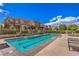 Community pool with lounge chairs and meticulously kept landscaping at 11178 Corsica Mist Ave, Las Vegas, NV 89135