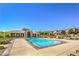 Community pool and clubhouse area featuring lounge chairs and landscaping at 11178 Corsica Mist Ave, Las Vegas, NV 89135