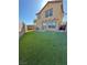 The backyard features artificial turf, a patio, and sliding glass door access to the home at 1155 Paradise Safari Dr, Henderson, NV 89002