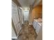 Hallway features neutral walls, doors, a laundry area, and tile flooring at 1155 Paradise Safari Dr, Henderson, NV 89002