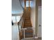 View of the staircase with wood railing, stair runner mats, and baby gate at 1155 Paradise Safari Dr, Henderson, NV 89002