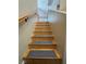 Carpeted stairs with wooden railing provides access to the upper level of the home at 1155 Paradise Safari Dr, Henderson, NV 89002