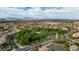 Panoramic aerial view showcases the neighborhood's community park amidst mountain views at 11732 Del Sur Ave, Las Vegas, NV 89138