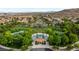 Aerial view of a community park featuring a playground, gazebo, trees, and pathways surrounded by homes at 11732 Del Sur Ave, Las Vegas, NV 89138