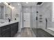 Modern bathroom showcasing marble walls, a glass-enclosed shower, and a sleek vanity with black hardware at 11732 Del Sur Ave, Las Vegas, NV 89138