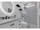 Modern bathroom featuring designer shower with decorative tile, black fixtures, vanity with make-up mirror and built in toilet at 11732 Del Sur Ave, Las Vegas, NV 89138