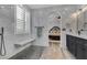 Bright bathroom features marble walls, hex tile flooring, a walk-in shower, and plantation shutters at 11732 Del Sur Ave, Las Vegas, NV 89138