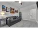 Spare bedroom with a comfortable couch, end table, lamp, and lots of decorative wall art at 11732 Del Sur Ave, Las Vegas, NV 89138