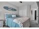 Serene bedroom with a surf-themed decor, carpet flooring, and access to the ensuite bathroom at 11732 Del Sur Ave, Las Vegas, NV 89138