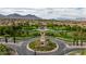 Community clock tower located in the center of a roundabout surrounded by greenery and homes at 11732 Del Sur Ave, Las Vegas, NV 89138