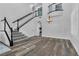 Bright dining room with modern chandelier, grand staircase and neutral colors at 11732 Del Sur Ave, Las Vegas, NV 89138