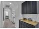 Elegant upstairs hallway features dark cabinetry with butcher block counters, and archways leading to carpeted bedrooms at 11732 Del Sur Ave, Las Vegas, NV 89138